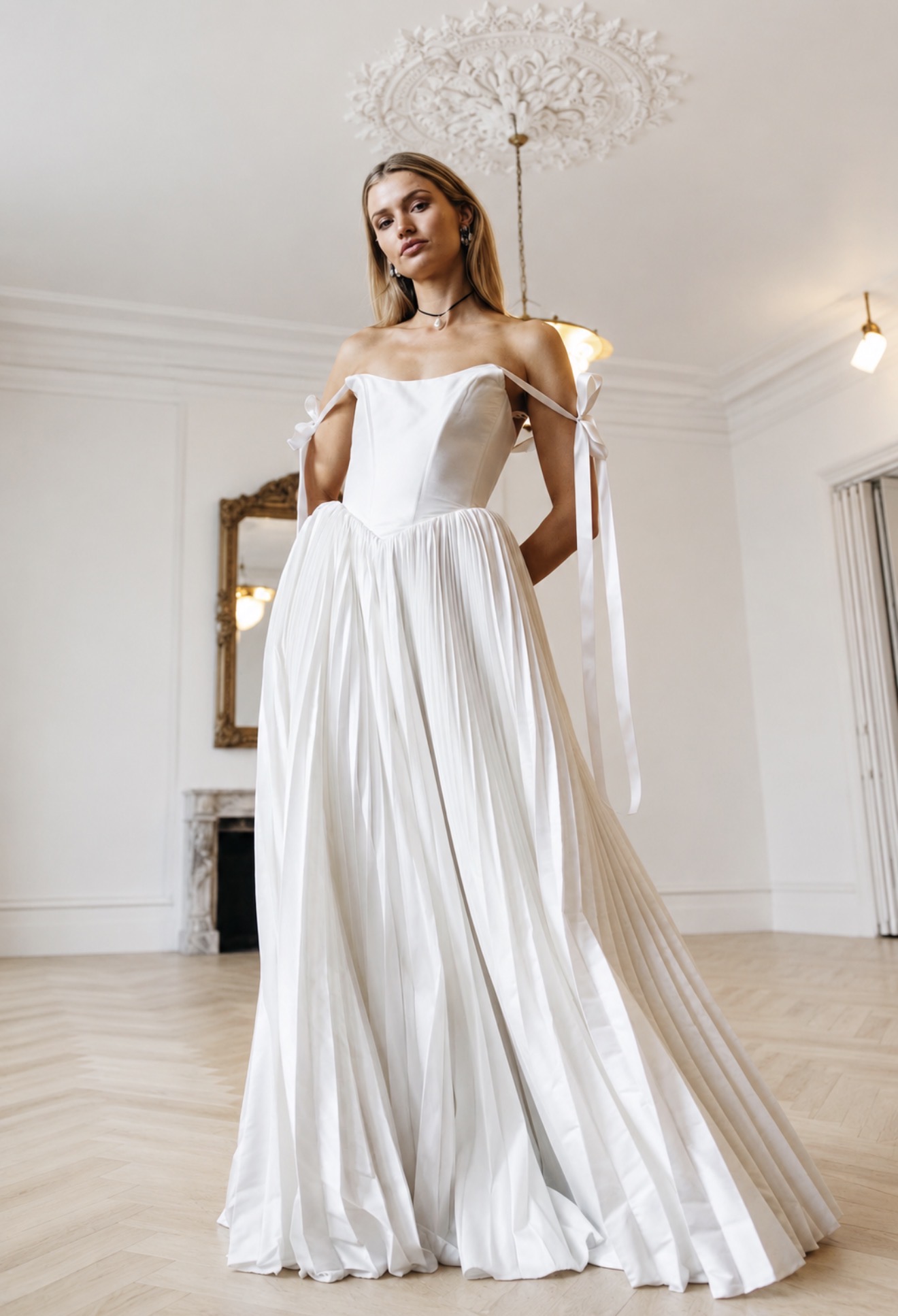 And For Love wedding gown — strapless corset bodice with pleated skirt and ribbon-tied sleeves